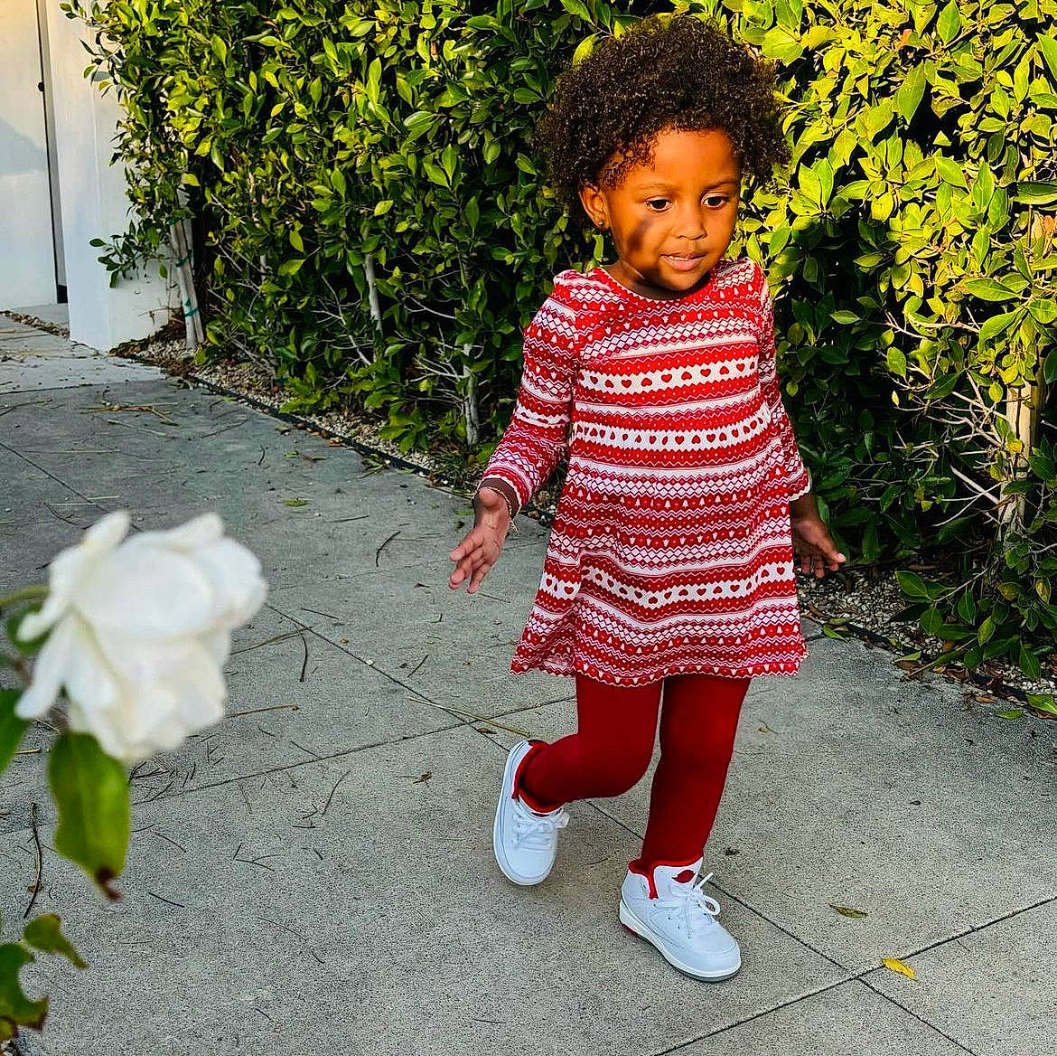 Jalaya joined the competition — help win amazing prizes! baby_toddler_clothing, clothing, face, grass, green, happy, human_leg, leaf, pattern, people_in_nature, person, petal, plant, road_surface, shoe, sidewalk, sleeve, smile, toddler, toy