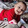 Jade participe au concours pour gagner de l'argent avec cette photo : baby, bed, blanket, child, closeup, crawling, cute, face, happy, head, indoor, infant, lying_down, patterned_bedspread, person, red_shirt, skin, smiling, soft_toys, toy