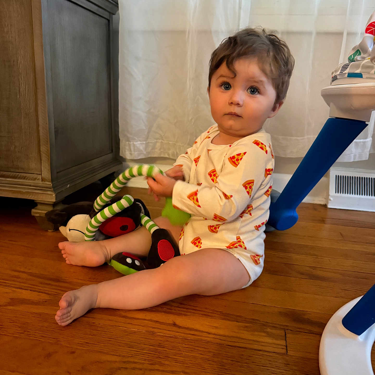 Vincent joined the competition — help win amazing prizes! toddler, child, baby, sitting, indoor, portrait, pajamas, pizza_pattern, plush_toy, stuffed_animal, toy, hardwood_floor, wooden_floor, cabinet, curtains, window, activity_table, home, family_photo, wide_eyed