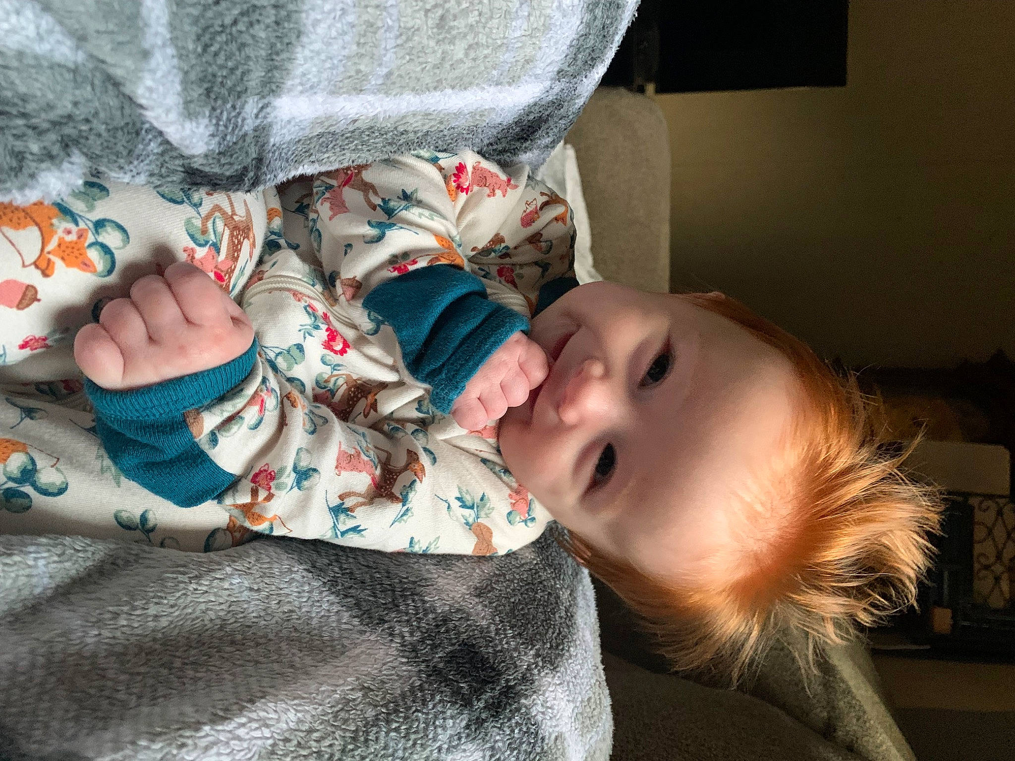 Phoebe is registered to the contest to win money with this photo: arm, baby, baby_products, baby_toddler_clothing, cheek, child, comfort, foot, happy, hat, human_body, joy, linens, mouth, pattern, person, room, sitting, sleeve, smile