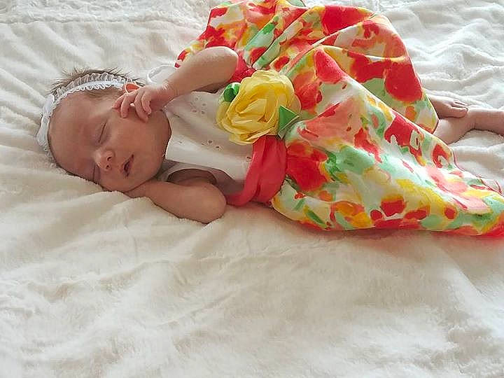 Joselyn is registered to the contest to win money with this photo: baby_products, bedtime, blanket, child, hair_accessory, infant, petal, pink, product, skin, sleep, textile, toddler