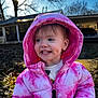Meadow is registered to the contest to win money with this photo: child, toddler, pink_jacket, hood, smile, dimples, teeth, outdoor, sunlight, backlit, tree, house, car, winter, coat, portrait, happy, grass, playful, young