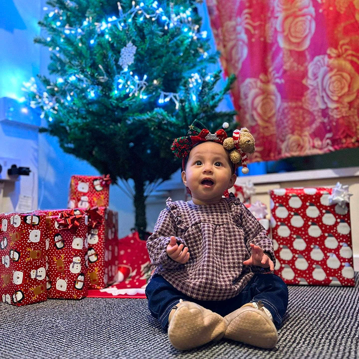 Nahia joined the competition — help win amazing prizes! baby, carpet, celebration, child, christmas_tree, clothing, cute, decorations, festive, gift_wrap, headband, holiday, holiday_lights, home, indoor, portrait, presents, seasonal, smiling, winter