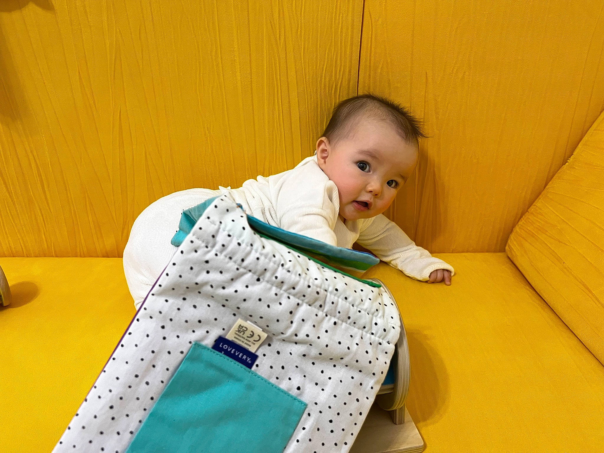 Mylah joined the competition — help win amazing prizes! baby, baby_products, baby_toddler_clothing, chair, child, comfort, electric_blue, floor, flooring, fun, leisure, linens, pattern, person, rectangle, room, sitting, sleeve, surprise, t_shirt