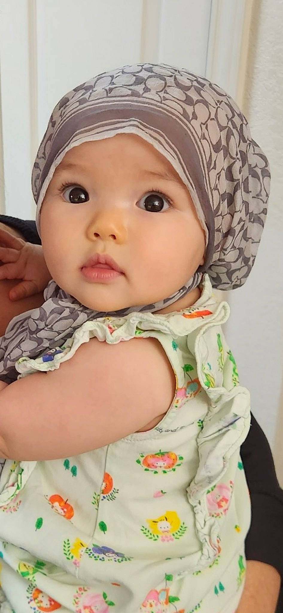 Mylah is registered to the contest to win money with this photo: baby, baby_toddler_clothing, cap, cheek, child, collar, dress, eyelash, face, happy, headgear, headwear, iris, lip, neck, nose, pattern, person, skin, sleeve