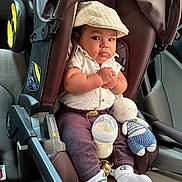 Eykel is registered to the contest to win money with this photo: baby, car_seat, infant, cap, white_shirt, knitted_doll, baby_bottle, car_interior, seatbelt, clothing, cute, child, socks, toy, portrait, young_child, casual, indoor, car, seat