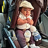 baby, car_seat, infant, cap, white_shirt, knitted_doll, baby_bottle, car_interior, seatbelt, clothing, cute, child, socks, toy, portrait, young_child, casual, indoor, car, seat