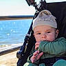 baby, beach, casual, child, clothing, cute, daytime, hat, infant, nature, ocean, outdoor, person, portrait, relaxing, seat, stroller, summer, sunlight, water