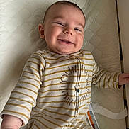 Bo joined the competition — help win amazing prizes! baby, bed, child, cozy, crib, cute, face, happy, indoor, infant, lying_down, onesie, pajamas, person, portrait, sleepwear, smiling, striped_clothing, toddler, young_child