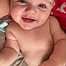 baby, smiling, blue_eyes, chubby, hand, blanket, red_background, hummingbird, cute, infant, skin, portrait, person, happy, lying_down, closeup, face, baby_skin, child, indoors