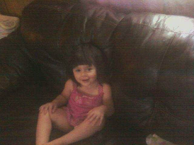 Julie Adrianna Marie is registered to the contest to win money with this photo: abdomen, black_hair, chest, child, comfort, couch, elbow, fun, human_leg, jaw, joy, lap, leg, long_hair, mouth, nose, person, sitting, thigh, thumb