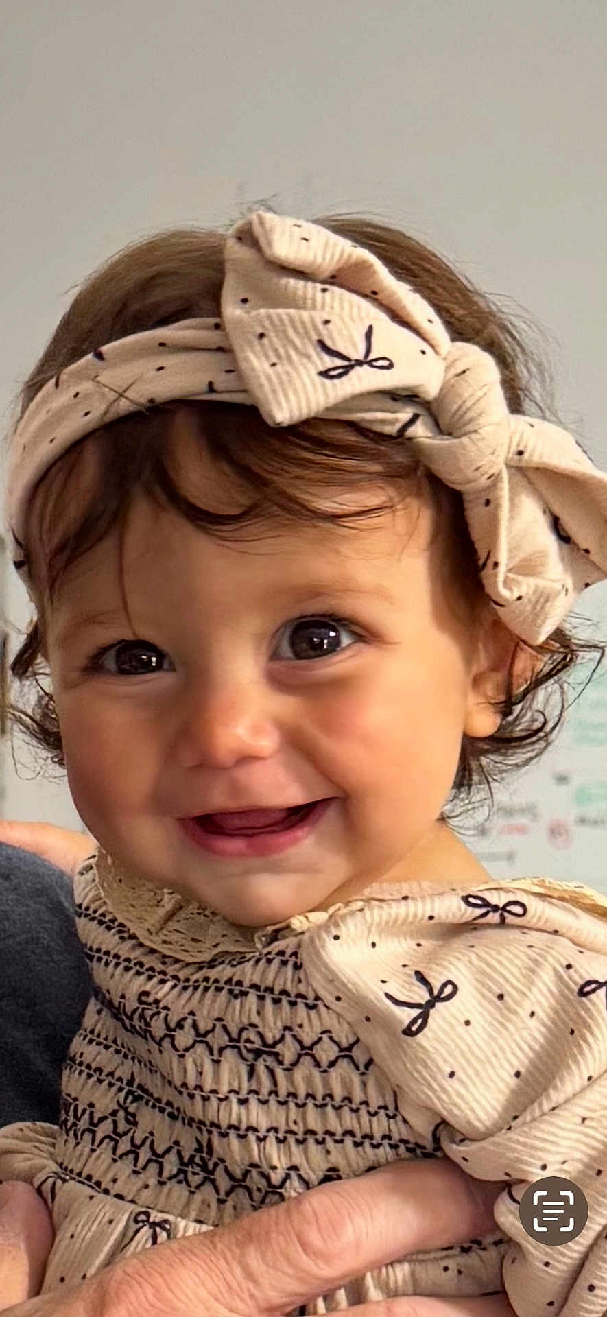 Melanie is registered to the contest to win money with this photo: baby, child, smile, headband, bow, dress, hand, face, eyes, cute, happy, portrait, infant, clothing, person, skin, hair, indoor, closeup, young