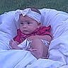 Ahvi is registered to the contest to win money with this photo: baby, infant, child, portrait, lying_down, bed, blanket, white_bedding, headband, clothing, red_shirt, indoors, bedroom, face, serious_expression, awake, sitting, cozy, closeup, photography
