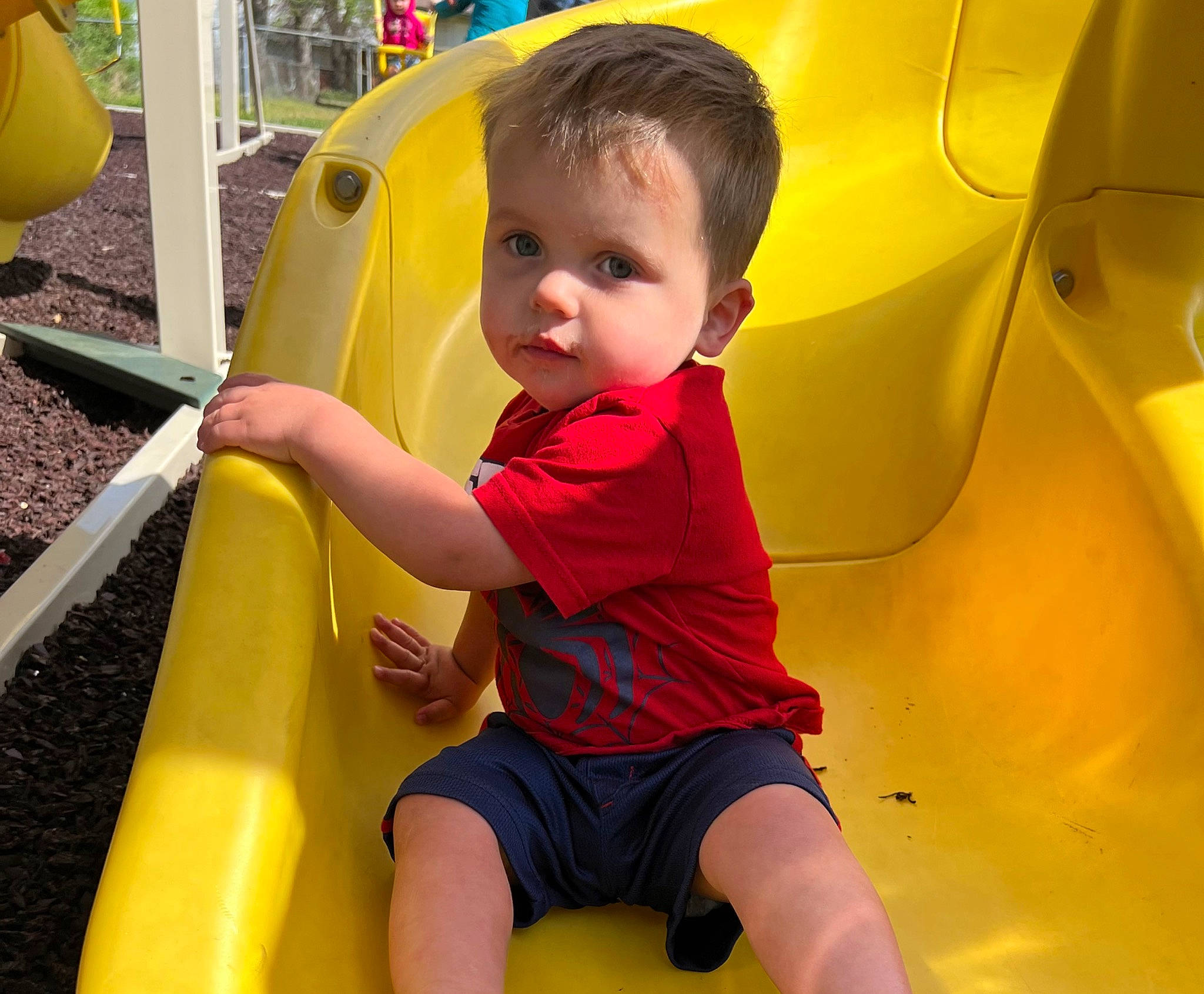 Karsyn is registered to the contest to win money with this photo: automotive_exterior, baby_toddler_clothing, bumper, child, chute, fun, green, leisure, motor_vehicle, person, photograph, playground, recreation, shorts, smile, snapshot, t_shirt, toddler, vehicle_door, white
