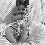 Annsley is registered to the contest to win money with this photo: baby, smiling, headband, bow, cushion, infant, cute, happy, sitting, clothing, onesie, hand, face, portrait, monochrome, texture, soft, comfort, child, indoors