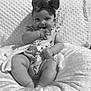 baby, smiling, headband, bow, cushion, infant, cute, happy, sitting, clothing, onesie, hand, face, portrait, monochrome, texture, soft, comfort, child, indoors