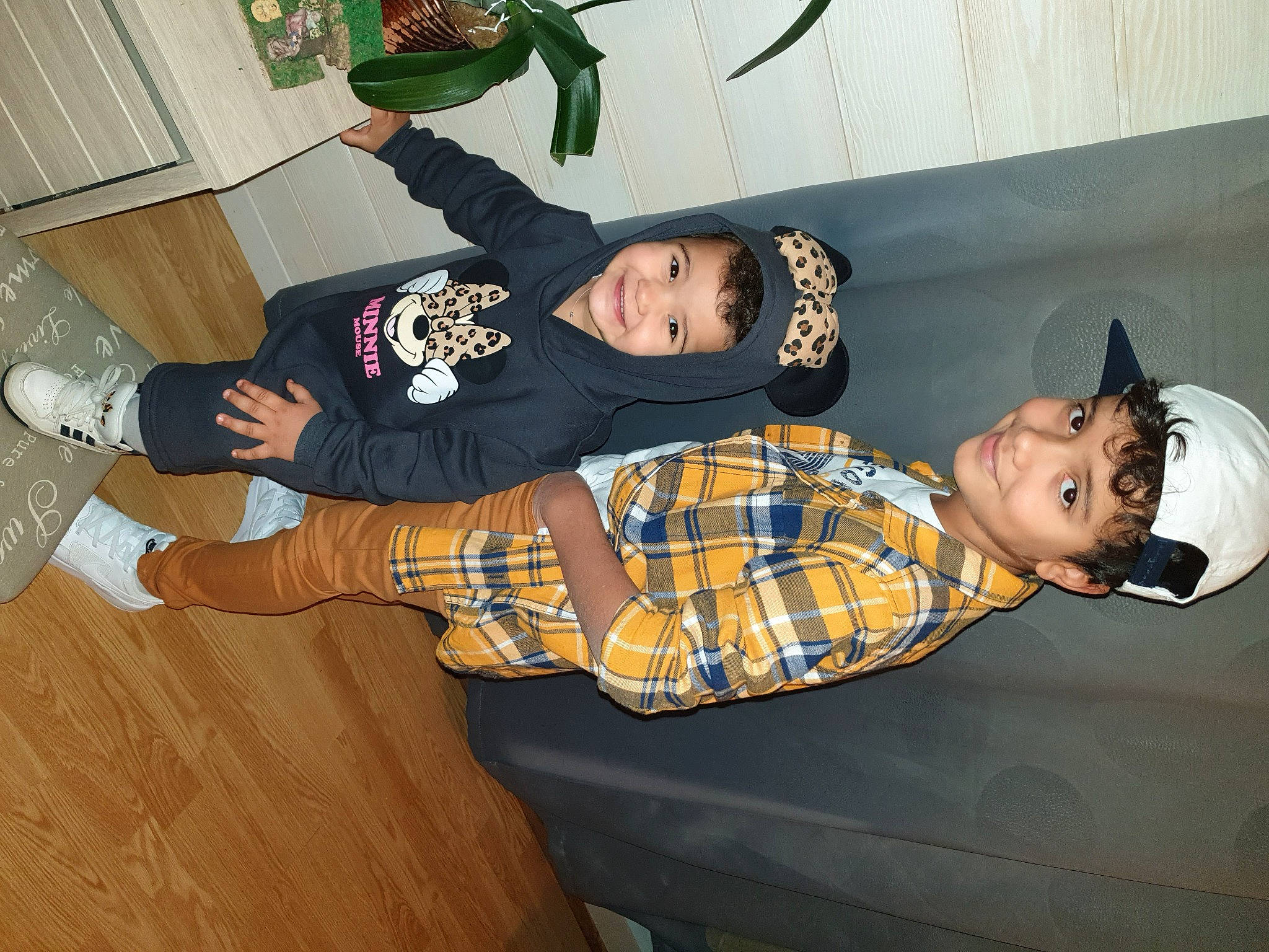 Angeline participe au concours pour gagner de l'argent avec cette photo : child, comfort, elbow, flooring, fun, happy, hardwood, hat, headwear, joy, knee, lap, pattern, person, plaid, room, sitting, smile, sock, t_shirt