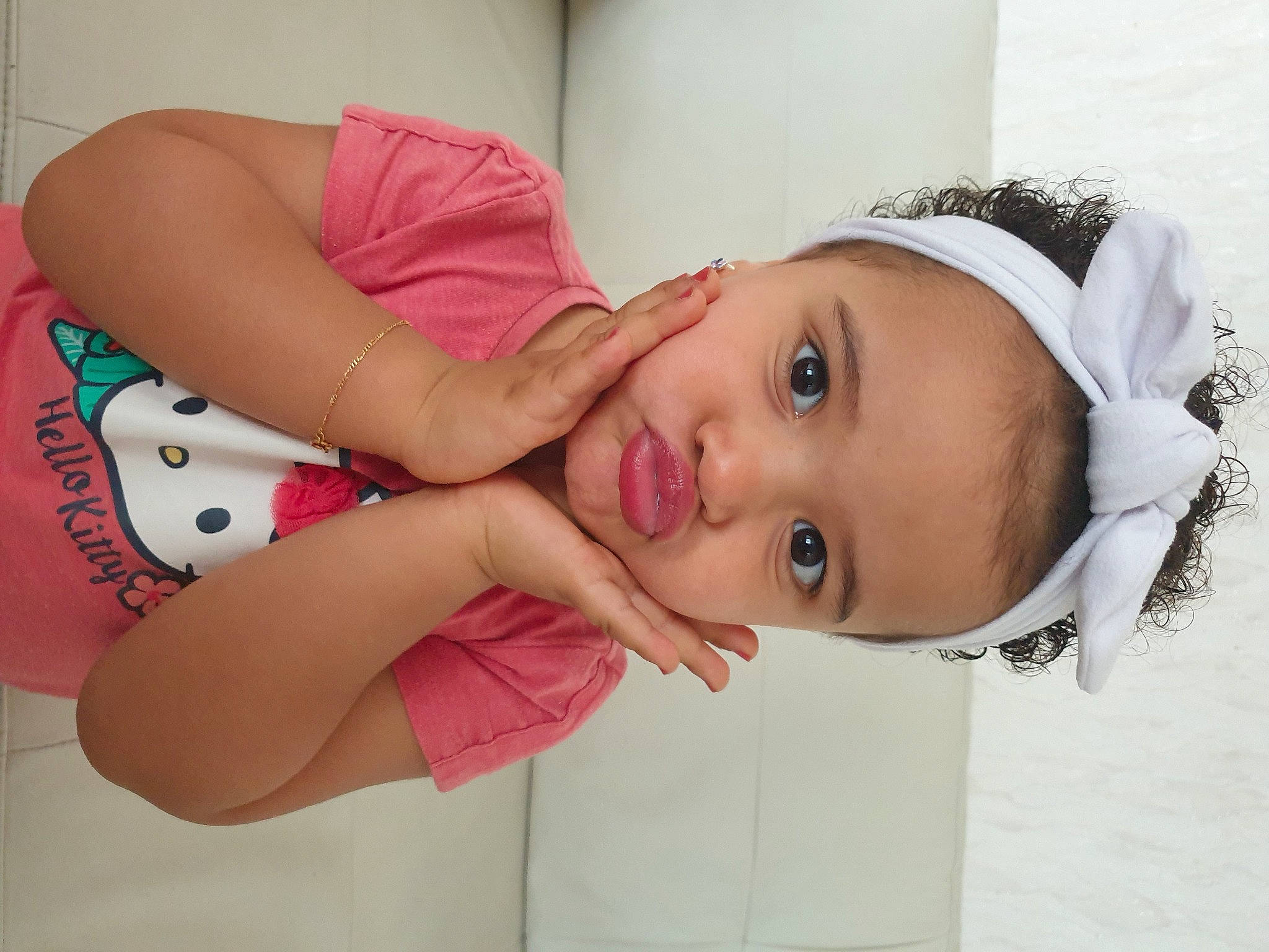 Angeline participe au concours pour gagner de l'argent avec cette photo : arm, baby, baby_toddler_clothing, cheek, child, dress, elbow, eyelash, fashion_accessory, fun, hair_accessory, happy, hat, lip, pattern, person, pink, room, skin, smile