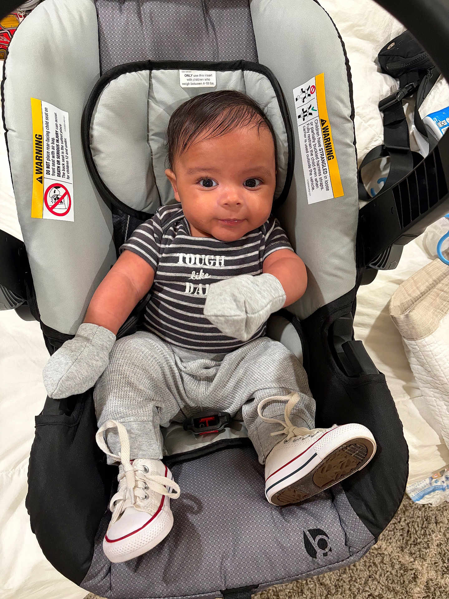 Kamaree joined the competition — help win amazing prizes! baby, infant, child, baby_carrier, clothing, mittens, sneakers, striped_shirt, smiling, indoor, car_seat, cute, young_child, person, footwear, baby_girl, baby_boy, black_hair, seated, closeup