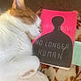Kitty Boy is registered to the contest to win money with this photo: cat, sleeping, book, cover, orange, white, fur, blanket, pattern, floral, nap, cozy, relaxing, indoors, quiet, rest, soft, pet, animal, comfort