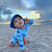 Kaison joined the competition — help win amazing prizes! toddler, beach, sand, ocean, sunset, clouds, child, hat, swimsuit, blue, playful, hand, sky, water, outdoor, nature, person, crawling, small_ball, summer