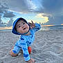 toddler, beach, sand, ocean, sunset, clouds, child, hat, swimsuit, blue, playful, hand, sky, water, outdoor, nature, person, crawling, small_ball, summer