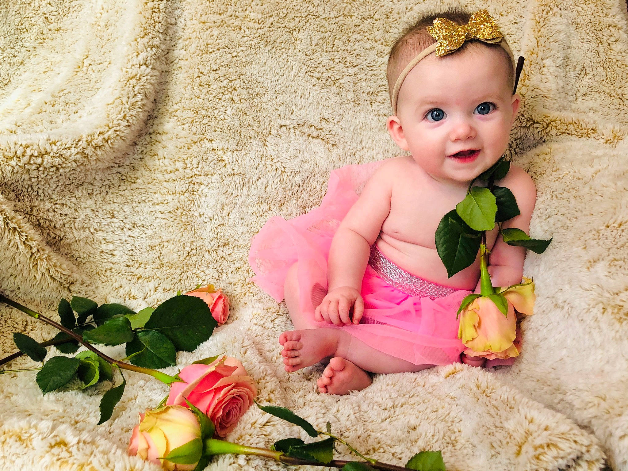 Oaklee is registered to the contest to win money with this photo: baby, beauty, blond, cheek, child, dress, flower, hair_accessory, human, person, petal, photograph, photography, pink, plant, product, sitting, skin, smile, textile