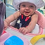 baby, child, smiling, hat, sunhat, outdoor, baby_walker, pink, toy, deck, house, happy, infant, person, clothing, reaching, seat, face, arm, daylight