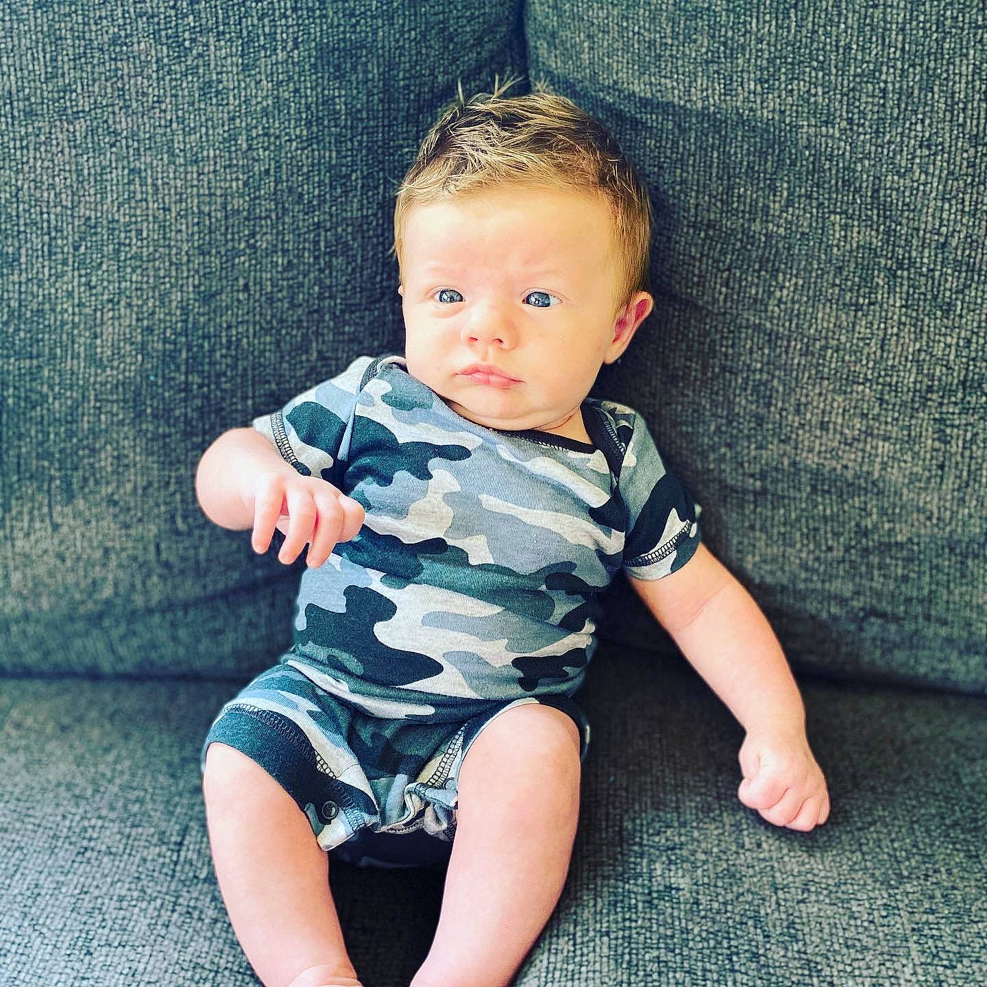 Maddux is registered to the contest to win money with this photo: baby, baby_toddler_clothing, cheek, child, cool, eye, face, head, leg, pattern, person, play, product, sitting, skin, smile, standing, summer, t_shirt, toddler