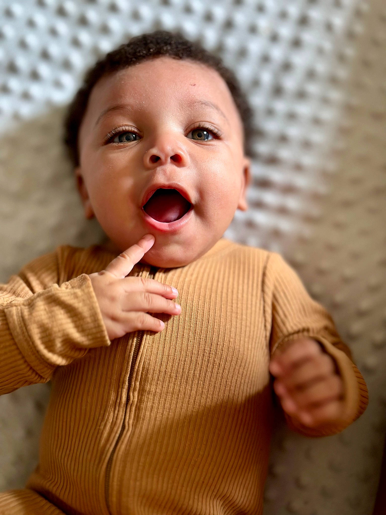 Joel is registered to the contest to win money with this photo: baby, baby_toddler_clothing, cheek, chin, clothing, eye, eyebrow, face, finger, gesture, hand, happy, iris, lip, mouth, nose, outerwear, person, skin, sleeve