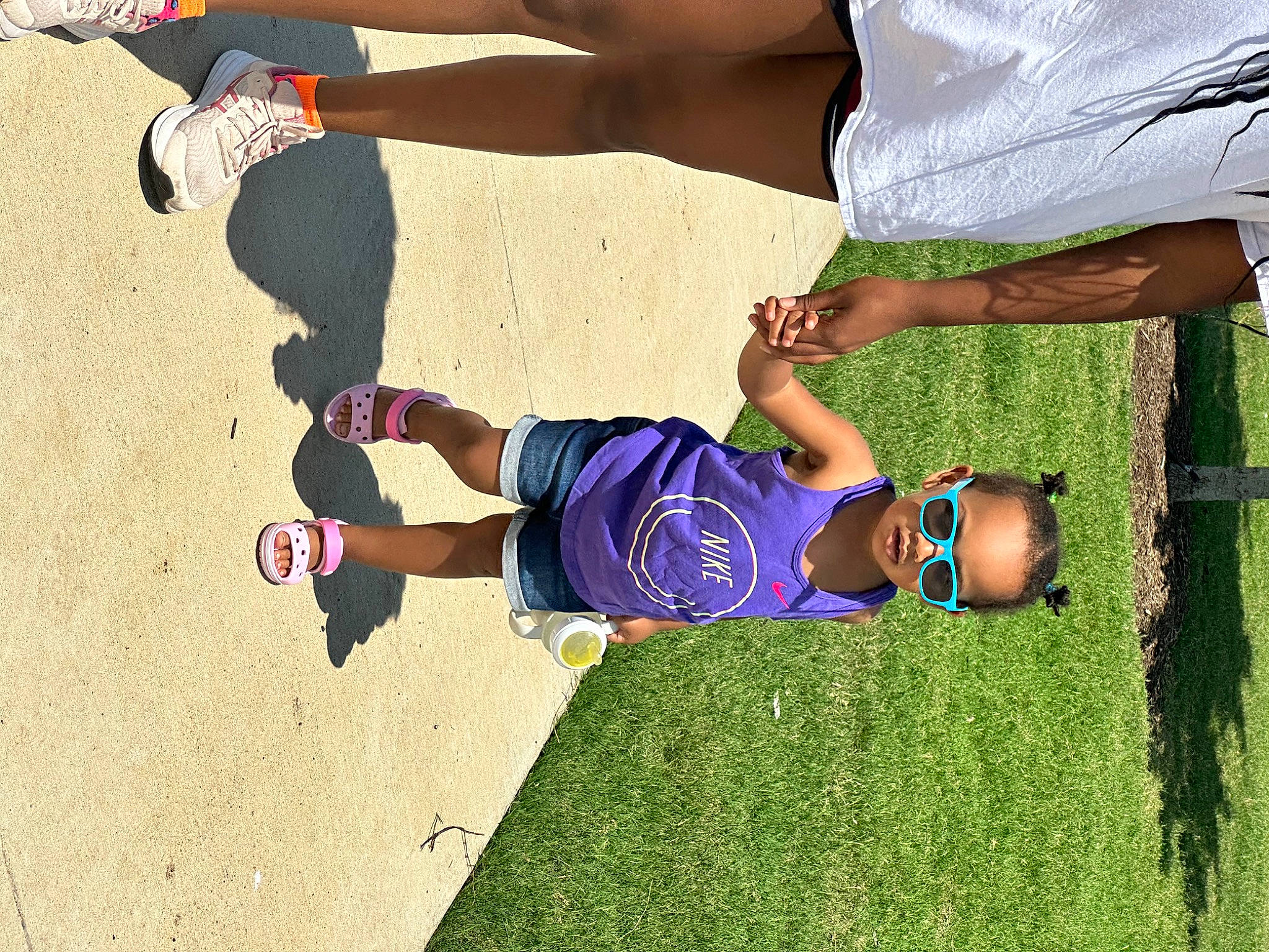 Noelle is registered to the contest to win money with this photo: electric_blue, foot, fun, grass, happy, human_body, human_leg, joint, knee, leg, leisure, people_in_nature, person, plant, recreation, shoe, shorts, sneakers, sock, t_shirt