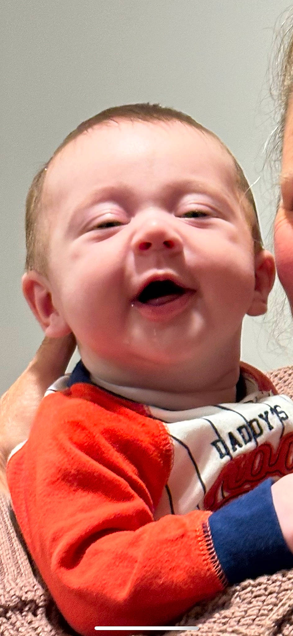 Matthew is registered to the contest to win money with this photo: baby, cheek, child, chin, event, finger, fun, gesture, happy, jaw, lip, mouth, nose, orange, person, red, skin, smile, throat, thumb