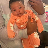 Janivea joined the competition — help win amazing prizes! baby, person, mirror, selfie, orange_clothing, flower_pattern, indoor, bedroom, window, curly_hair, holding, smile, phone, reflection, plaid_shorts, skin, hand, foot, fabric, casual