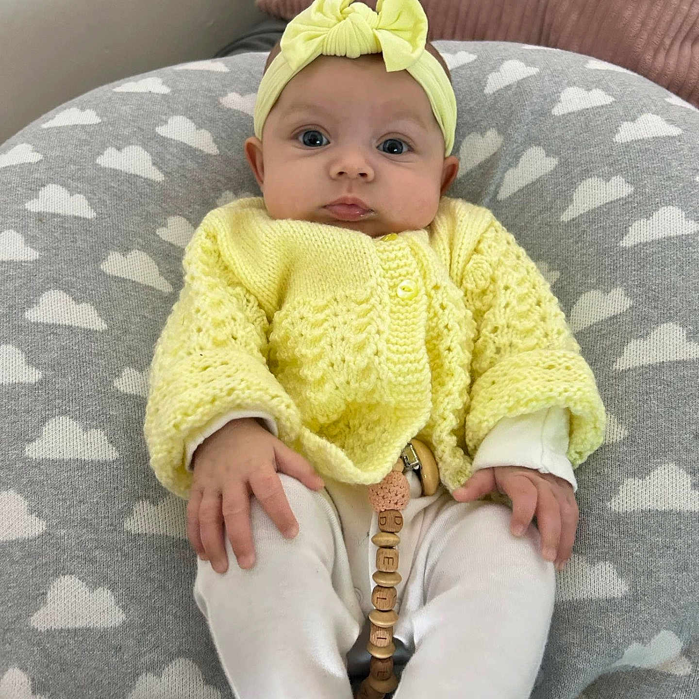 Delilah-Rae joined the competition — help win amazing prizes! baby, blanket, bonnet, cap, clothing, couch, face, furniture, hat, head, knitwear, pants, person, sitting, sleeve, sweater