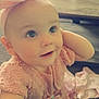 Lylianna is registered to the contest to win money with this photo: apparel, baby, candid, carpet, child, curious, cute, face, hand, headband, indoor, infant, person, pink_dress, portrait, room, smiling, soft_lighting, table, young_child