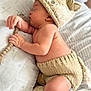 Leilani is registered to the contest to win money with this photo: baby, newborn, sleeping, hat, knit_hat, pacifier, pacifier_clip, beads, blanket, pillow, bedding, bed, hand, arm, torso, knitted_diaper, flower, soft_focus, portrait, cozy