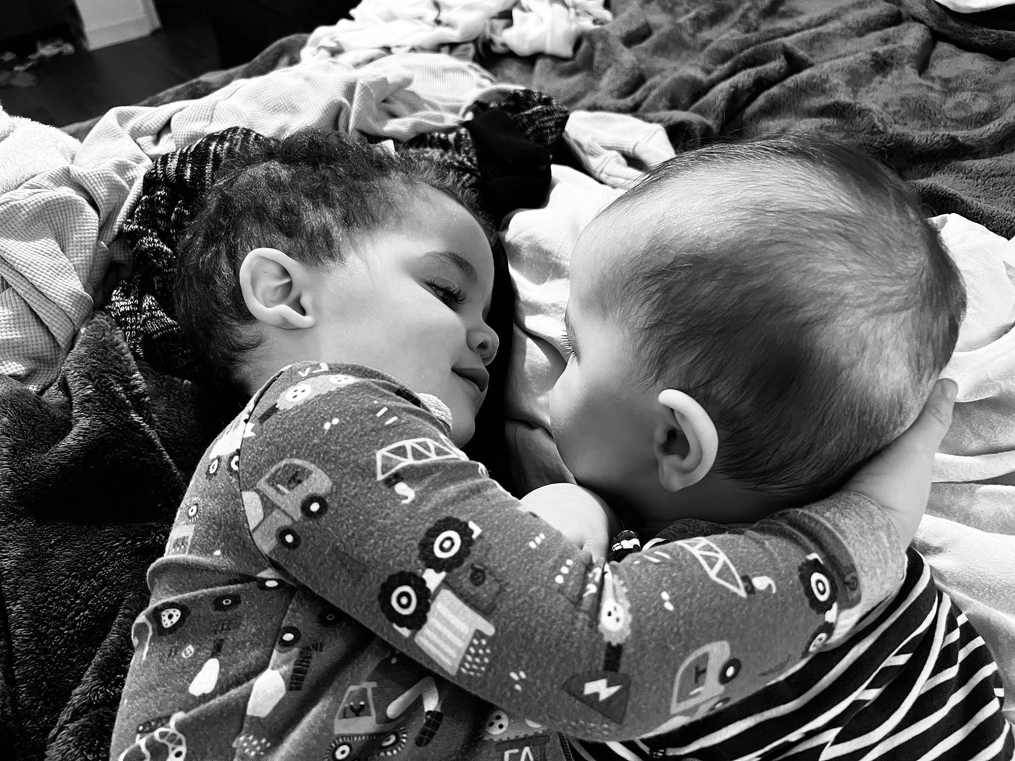 Jayden is registered to the contest to win money with this photo: baby, black, black_and_white, cheek, child, comfort, facial_expression, fun, gesture, hairstyle, happy, head, interaction, organ, people_in_nature, person, photograph, skin, style, toddler