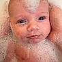 baby, infant, bathtub, bubbles, foam, face, eyes, hand, adult_hand, bath, closeup, portrait, skin, cheeks, wet, smile, gaze, water, cute, parenting