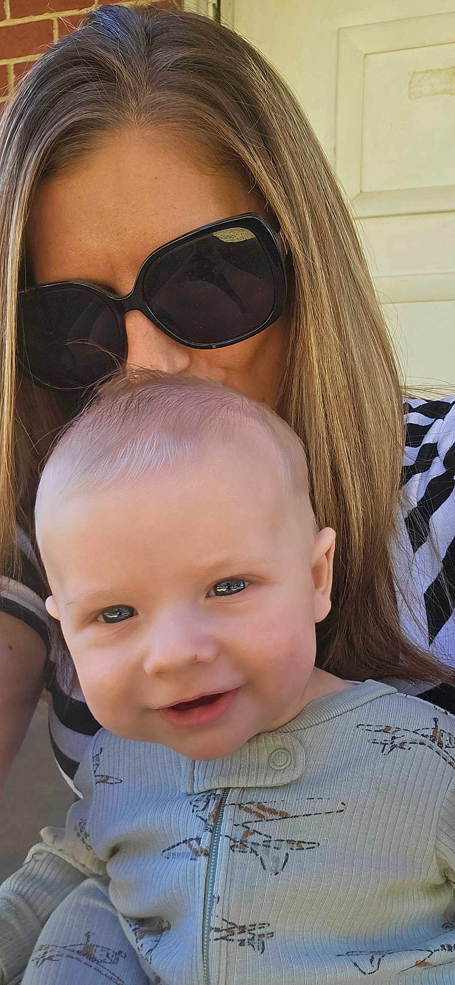 Rodger joined the competition — help win amazing prizes! baby, child, woman, sunglasses, smile, face, portrait, outdoor, person, clothing, pajamas, hair, head, expression, affection, mother, holding, closeup, happy, family