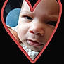 baby, face, close_up, heart_shape, expression, infant, skin, portrait, curious, cute, black_background, red_heart, child, young, head, eyes, nose, mouth, clothing, texture