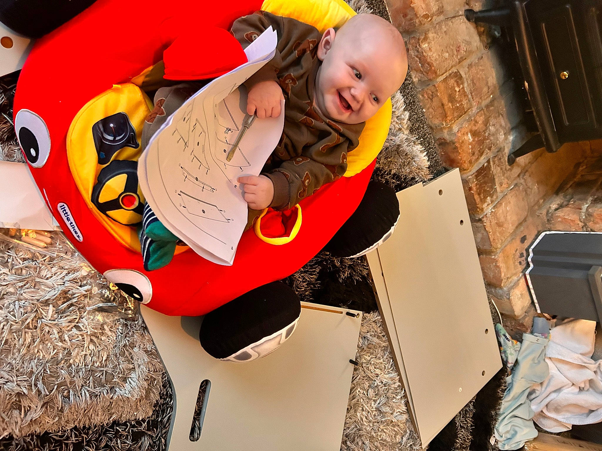 Kai is registered to the contest to win money with this photo: baby, baby_toddler_clothing, cap, carmine, child, costume_hat, event, fun, happy, hat, leisure, person, pumpkin, recreation, smile, t_shirt, toddler, wood