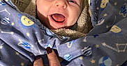 Gunnison joined the competition — help win amazing prizes! animal_print, baby, blanket, blue, cozy, cute, face, fingers, giraffe_print, hand, happy, infant, moon, nail_polish, person, smile, stars, toddler, warm, wrapped