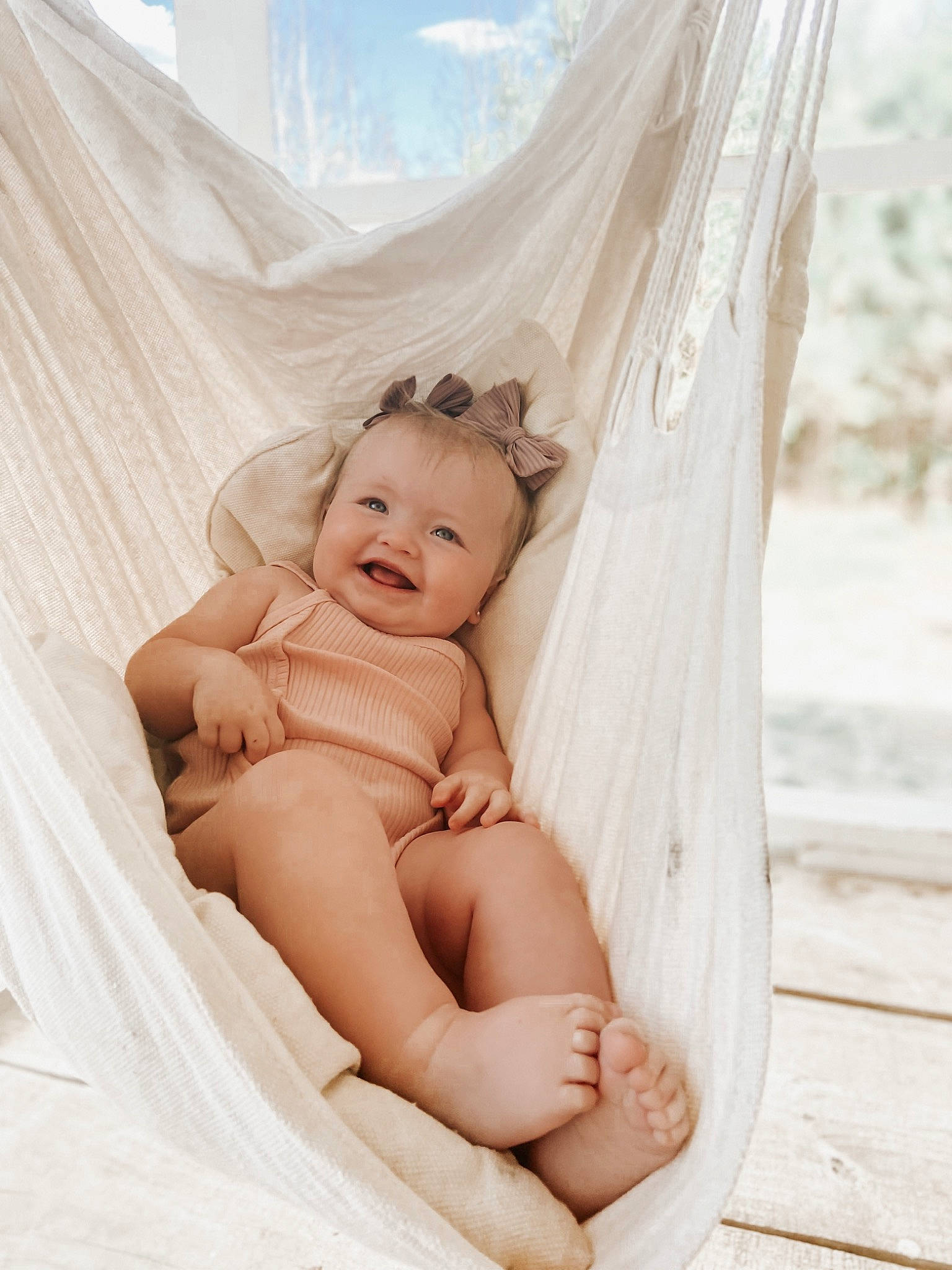 Blakelynn is registered to the contest to win money with this photo: abdomen, baby, baby_toddler_clothing, barefoot, child, comfort, fashion_accessory, flash_photography, foot, fun, happy, human_leg, joy, leisure, linens, peach, person, portrait_photography, sitting, smile