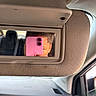automobile, car, child, closeup, dashboard, face, indoor, interior, mirror, passenger, photography, pink_phone, portrait, reflection, seated, selfie, smartphone, sun_visor, upside_down, vehicle