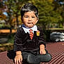 Thiago is registered to the contest to win money with this photo: toddler, child, outdoor, park, bench, costume, harry_potter, tie, collar, face, hands, autumn, trees, sunlight, portrait, cute, black_hair, expression, clothing, daytime