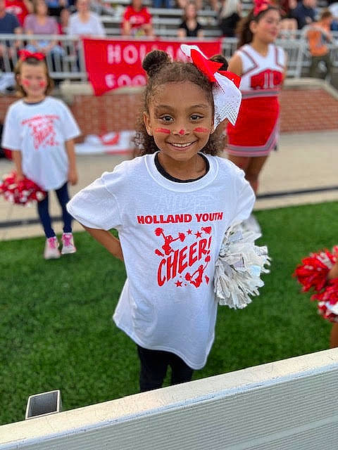 Jocelynn is registered to the contest to win money with this photo: blurred, championship, cheerleading_uniform, community, competition_event, fun, grass, happy, jersey, joy, mammal, person, player, red, sleeve, smile, sports, sports_uniform, sportswear, summer