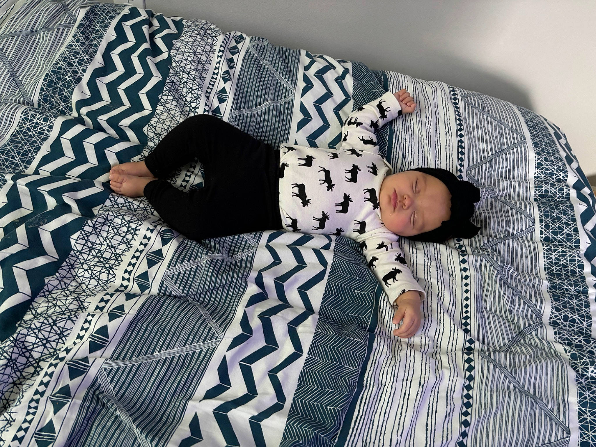 Laiklynn is registered to the contest to win money with this photo: baby_toddler_clothing, bed_sheet, bedding, child, comfort, couch, flooring, headwear, linens, pattern, person, rectangle, room, sitting, sleeve, textile, toddler, tree, wood, woven_fabric