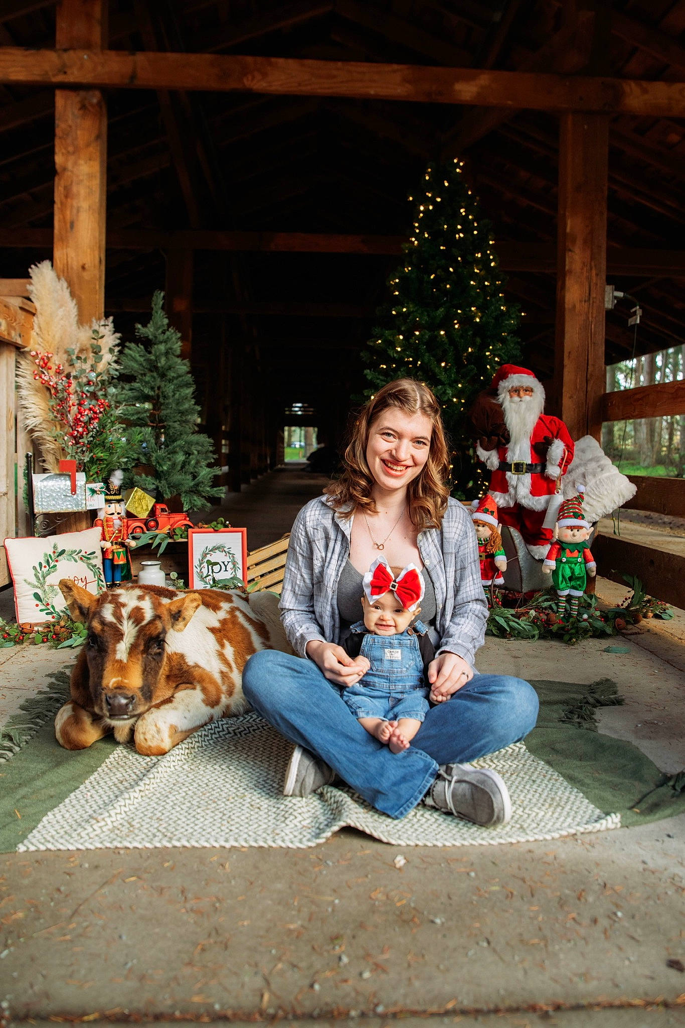 Kaidyn is registered to the contest to win money with this photo: carnivore, christmas, christmas_decoration, christmas_ornament, christmas_tree, event, fun, happy, holiday, holiday_ornament, jeans, joy, lap, leisure, person, plant, smile, temple, tree, winter