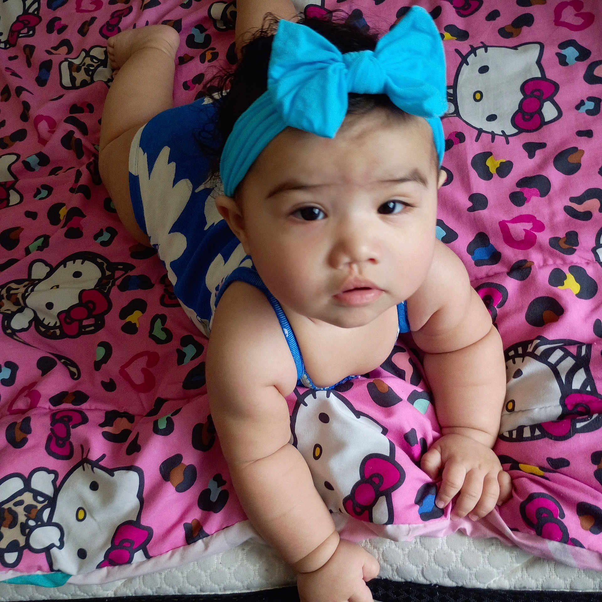 Yuli joined the competition — help win amazing prizes! baby, child, headband, blue, bow, hello_kitty, blanket, pink, pattern, curious, face, infant, cute, indoors, person, skin, hand, lying_down, plush, clothing