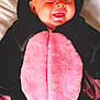 Ivy is registered to the contest to win money with this photo: baby, bed, black, child, costume, cozy, cute, face, happy, hood, infant, lying_down, onesie, pink, playful, portrait, sleepwear, smiling, soft, tongue